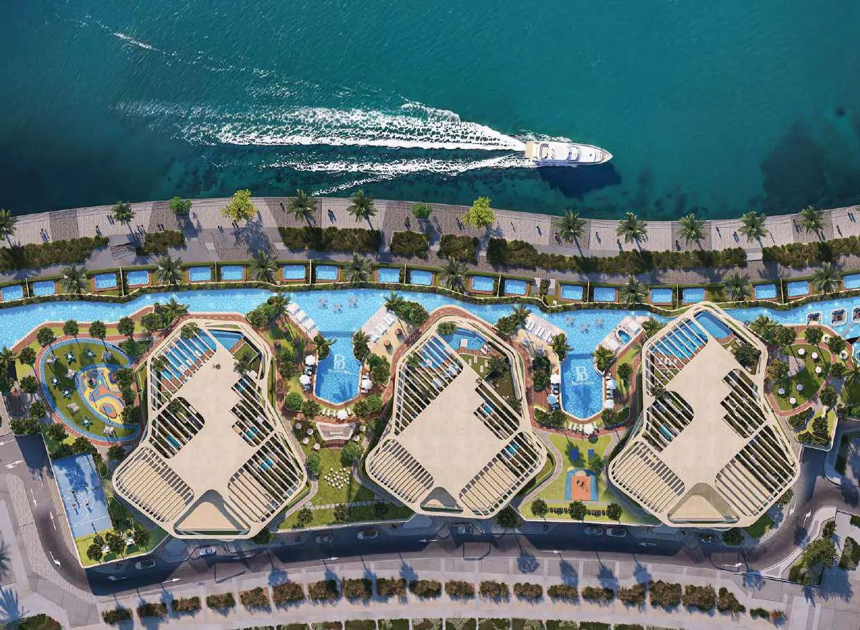 Aerial view of Bab Al Qasr Residence 51 in Al Raha Beach Abu Dhabi showcasing three waterfront towers and greenery.
