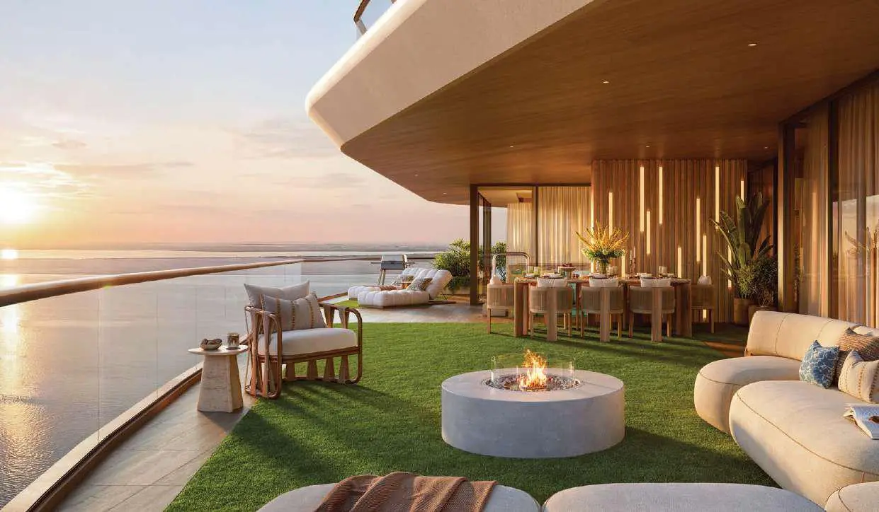 Sunset view of three curved residential towers and waterfront promenade at Bab Al Qasr Residence 51 Al Raha Beach.
