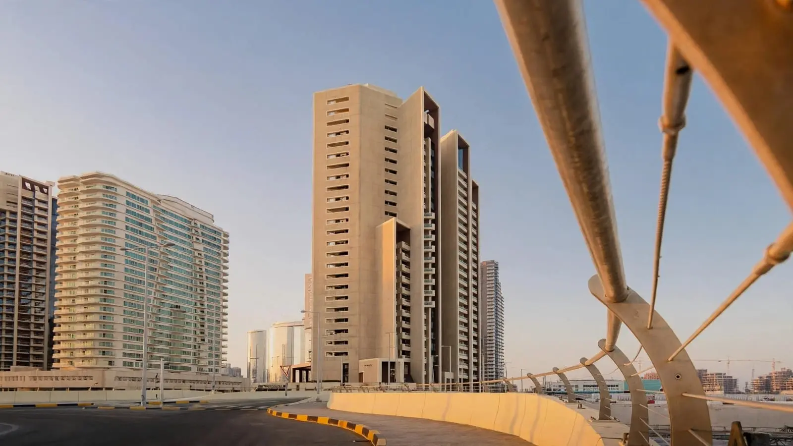 Najmat Abu Dhabi Baheen Tower exterior highlighting contemporary tower architecture, landscaped pathways, and vibrant waterfront residential lifestyle.