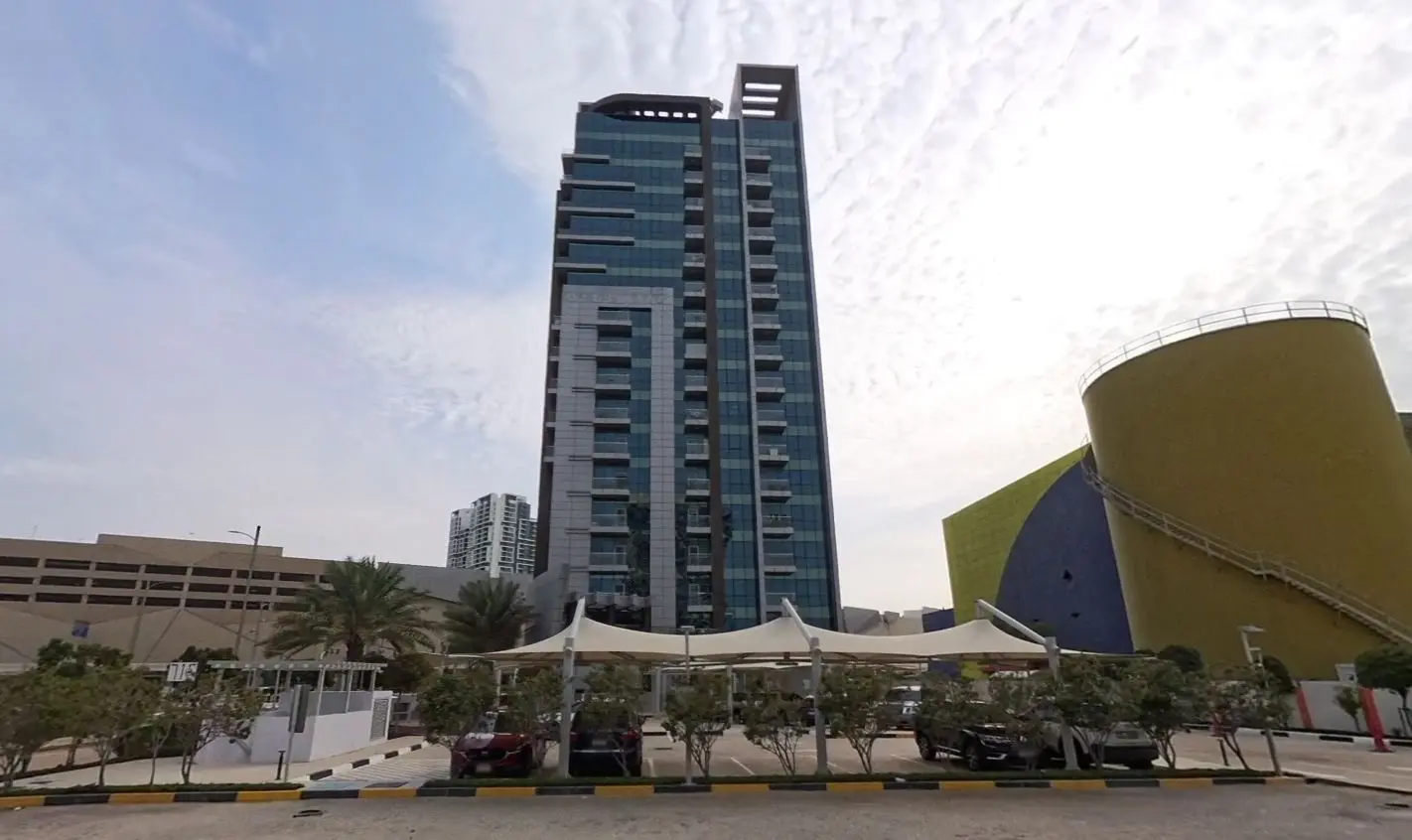 Scenic waterfront exterior view of Al Noor Tower surrounded by the Al Reem Island skyline and canal views.