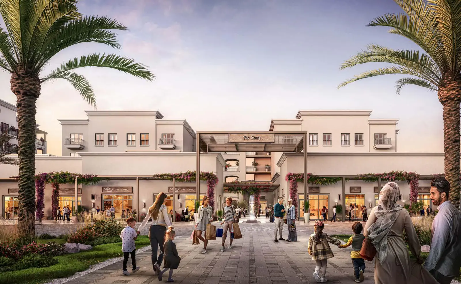 Evening view of Souq Furnished Apartments Yas Island Abu Dhabi exteriors with lighting and landscaped spaces..jpg