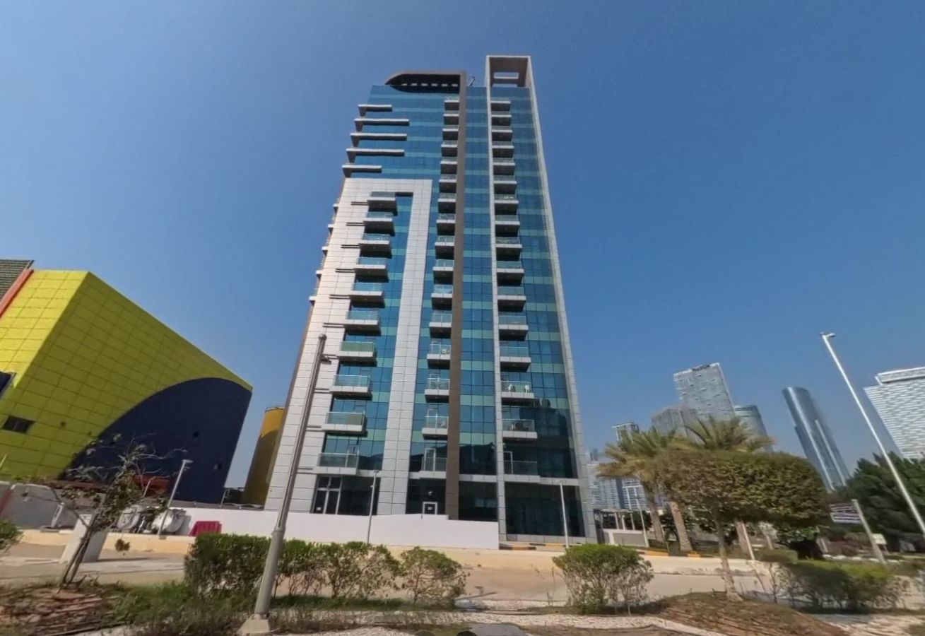 Architectural exterior glass facade of Al Noor Tower high-rise residential building on Al Reem Island Abu Dhabi.